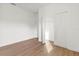 Empty Bedroom with wood flooring, bright white walls, and open closet doors at 13247 Sw 83Rd Cir, Ocala, FL 34473