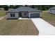 Charming single-story home with a well-manicured lawn and a two-car garage at 13247 Sw 83Rd Cir, Ocala, FL 34473