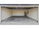 A spacious garage with concrete flooring, block walls, and a water heater, offering secure parking and ample storage space at 13247 Sw 83Rd Cir, Ocala, FL 34473