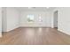 Open-concept living room featuring a large window and wood-style laminate flooring at 13247 Sw 83Rd Cir, Ocala, FL 34473