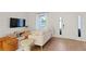 Cozy living room featuring neutral decor, a large window, and a modern entertainment center at 13247 Sw 83Rd Cir, Ocala, FL 34473