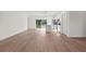 Open-concept living room with wood flooring, connecting to the kitchen and outdoor views at 13247 Sw 83Rd Cir, Ocala, FL 34473