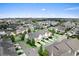 Aerial view of a neighborhood with well-maintained houses, green lawns, and a large lake in the distance at 13865 Granger Ave, Orlando, FL 32827