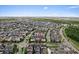 An aerial view showcases a vibrant neighborhood with lush greenery and waterways at 13865 Granger Ave, Orlando, FL 32827