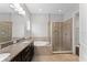 This modern bathroom has dual sinks, a glass enclosed shower, and soaking tub at 13865 Granger Ave, Orlando, FL 32827