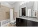 Bathroom with neutral color palette, a tiled shower, and a granite vanity at 13865 Granger Ave, Orlando, FL 32827
