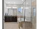 This bathroom is well-lit and has dual sinks, a glass enclosed shower, and soaking tub at 13865 Granger Ave, Orlando, FL 32827