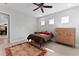 This well lit bedroom features hardwood floors, stylish furniture, and a ceiling fan at 13865 Granger Ave, Orlando, FL 32827