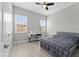 Bedroom with ceiling fan, wood-look floors, and natural light from two windows at 13865 Granger Ave, Orlando, FL 32827