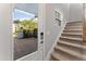 Light-filled entryway featuring tiled flooring and a carpeted staircase at 13865 Granger Ave, Orlando, FL 32827