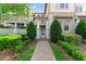 Inviting front entrance with a brick walkway, mature landscaping, and a private gated courtyard at 13865 Granger Ave, Orlando, FL 32827