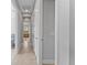 Hallway featuring doors, neutral paint, baseboards and tile floors at 13865 Granger Ave, Orlando, FL 32827