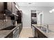 Well-appointed kitchen with granite countertops and stainless steel appliances and tiled floor at 13865 Granger Ave, Orlando, FL 32827