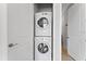 Laundry closet featuring stacked washer and dryer with white doors and neutral paint at 13865 Granger Ave, Orlando, FL 32827