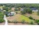 Aerial view of a luxury home with a pool surrounded by lush landscaping near a lake at 1415 Brumley Rd, Chuluota, FL 32766