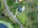 Aerial view of home with a large lot, pool, and curved driveway in a treed neighborhood at 1415 Brumley Rd, Chuluota, FL 32766