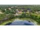 Aerial view of a community of luxury homes near a lake and surrounded by lush greenery at 1415 Brumley Rd, Chuluota, FL 32766