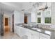 Bathroom with dual sinks, granite countertops, tile flooring, and a large mirror at 1415 Brumley Rd, Chuluota, FL 32766