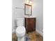 Bathroom features a toilet, vanity with dark wood cabinets and tile floors at 1415 Brumley Rd, Chuluota, FL 32766