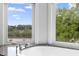 Close-up of a soaking tub with granite countertops and abundant natural light from surrounding windows at 1415 Brumley Rd, Chuluota, FL 32766