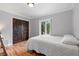Comfortable bedroom featuring hardwood floors and view of backyard at 1415 Brumley Rd, Chuluota, FL 32766