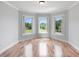 Bright bedroom featuring hardwood floors and large windows offering beautiful outdoor views at 1415 Brumley Rd, Chuluota, FL 32766