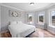 Cozy bedroom with natural light, wood floors, and charming decor at 1415 Brumley Rd, Chuluota, FL 32766