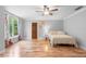 This bedroom features hardwood flooring, a ceiling fan, and a picturesque window at 1415 Brumley Rd, Chuluota, FL 32766