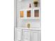 White built-in shelving with colored glass doors and decorative items at 1415 Brumley Rd, Chuluota, FL 32766