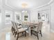 Dining room featuring elegant chandelier, marble floors, and large windows at 1415 Brumley Rd, Chuluota, FL 32766