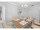 Dining room with chandelier, table set for a formal meal at 1415 Brumley Rd, Chuluota, FL 32766