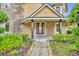 Charming entryway with decorative door, manicured shrubs and flower beds at 1415 Brumley Rd, Chuluota, FL 32766