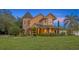 Charming home exterior featuring a covered porch, manicured landscaping, and unique architectural details at 1415 Brumley Rd, Chuluota, FL 32766