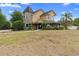 A stunning two-story home featuring a turret and a well-manicured front lawn at 1415 Brumley Rd, Chuluota, FL 32766