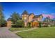 Stately exterior showcasing a unique turret design, lush landscaping, and inviting pathway to the front entrance at 1415 Brumley Rd, Chuluota, FL 32766