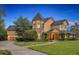 Stately exterior showcasing a unique turret design, lush landscaping, and inviting pathway to the front entrance at 1415 Brumley Rd, Chuluota, FL 32766