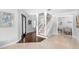 Bright foyer showcasing a grand staircase, hardwood and marble flooring, and elegant design details at 1415 Brumley Rd, Chuluota, FL 32766