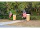 A grand gated entrance with two American flags adds security and curb appeal at 1415 Brumley Rd, Chuluota, FL 32766