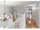 A view of the home's hallway with wood flooring and a decorative chandelier at 1415 Brumley Rd, Chuluota, FL 32766