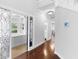 Hallway with hardwood floors and elegant detailing, leading to rooms filled with natural light and charm at 1415 Brumley Rd, Chuluota, FL 32766