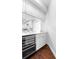 Kitchen featuring a wine cooler, white cabinets, light countertops and hardwood floors at 1415 Brumley Rd, Chuluota, FL 32766