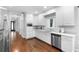 Bright, spacious kitchen featuring white cabinets, stainless steel appliances and hardwood floors at 1415 Brumley Rd, Chuluota, FL 32766