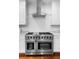 Close up on chef-style stainless steel oven and range with white cabinetry and granite countertops at 1415 Brumley Rd, Chuluota, FL 32766