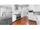 Bright, spacious kitchen featuring white cabinets, stainless steel appliances and hardwood floors at 1415 Brumley Rd, Chuluota, FL 32766