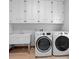 Clean laundry room with white cabinets, sink, washer and dryer at 1415 Brumley Rd, Chuluota, FL 32766