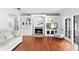 Cozy living room with hardwood floors, built in cabinets, and fireplace at 1415 Brumley Rd, Chuluota, FL 32766