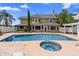 Beautiful backyard oasis featuring a pool, hot tub, and lush landscaping at 1415 Brumley Rd, Chuluota, FL 32766