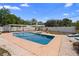 Inviting pool featuring white pergola, stone benches and meticulous landscaping at 1415 Brumley Rd, Chuluota, FL 32766