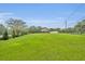 Expansive green property showcasing a well-maintained lawn and a beautiful home in the distance at 1415 Brumley Rd, Chuluota, FL 32766