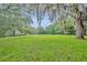 Scenic view of a lush green property with mature trees draped in Spanish moss at 1415 Brumley Rd, Chuluota, FL 32766